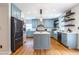 Bright kitchen boasts custom cabinets, stainless appliances, and a center island with white countertops at 333 Mimosa Dr, Decatur, GA 30030