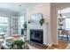 Open-concept living room boasts a fireplace, and flows to a dining room with modern chandelier at 333 Mimosa Dr, Decatur, GA 30030