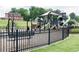 A fenced playground with swings and climbing structures, perfect for Gathering fun and outdoor activities at 612 Belshire Dr, Acworth, GA 30102