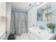 Bathroom showcasing a vanity sink, framed mirror, patterned shower curtain and natural light at 1222 Crestwood Se Dr, Atlanta, GA 30316