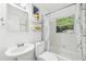 Bathroom featuring a single sink, built in tub, white tile, modern fixtures and natural light at 1222 Crestwood Se Dr, Atlanta, GA 30316