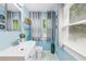 Cozy bathroom with a modern sink, decoratively tiled walls, framed mirror, and natural lighting at 1222 Crestwood Se Dr, Atlanta, GA 30316