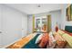 Bedroom with decorative pillows, natural light, hardwood flooring, and eye-catching artwork at 1222 Crestwood Se Dr, Atlanta, GA 30316