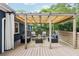 Inviting covered deck featuring stylish outdoor seating and ambient string lights for relaxing and entertaining at 1222 Crestwood Se Dr, Atlanta, GA 30316