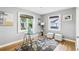 Office space with hardwood floors, glass desk, natural lighting, neutral walls, and contemporary artwork at 1222 Crestwood Se Dr, Atlanta, GA 30316