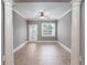 Bright bonus room with tile flooring, white columns, and access to the outdoors at 1640 Arbor Green Nw Ct # 1102, Kennesaw, GA 30152