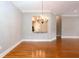 Elegant dining space featuring hardwood floors, a chandelier, and a pass-through to the kitchen at 1640 Arbor Green Nw Ct # 1102, Kennesaw, GA 30152