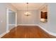 Elegant dining area featuring hardwood floors, chandelier, and a pass-through to the kitchen at 1640 Arbor Green Nw Ct # 1102, Kennesaw, GA 30152