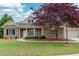 Charming brick home featuring a well-manicured lawn, mature tree, and an attached two-car garage at 1640 Arbor Green Nw Ct # 1102, Kennesaw, GA 30152