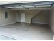Attached garage featuring concrete flooring and a utility door at 1640 Arbor Green Nw Ct # 1102, Kennesaw, GA 30152
