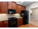 A kitchen featuring wood cabinets, stainless steel appliances, and granite countertops at 1640 Arbor Green Nw Ct # 1102, Kennesaw, GA 30152