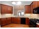 A kitchen featuring wood cabinets, stainless steel appliances, and granite countertops at 1640 Arbor Green Nw Ct # 1102, Kennesaw, GA 30152