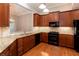 A kitchen featuring wood cabinets, stainless steel appliances, and granite countertops at 1640 Arbor Green Nw Ct # 1102, Kennesaw, GA 30152