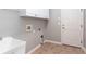 Laundry room features a utility sink, tile flooring, and ample storage at 1640 Arbor Green Nw Ct # 1102, Kennesaw, GA 30152