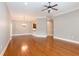 Open living room with hardwood floors, chandelier, and neutral paint colors at 1640 Arbor Green Nw Ct # 1102, Kennesaw, GA 30152