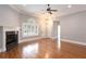 Bright living room with hardwood flooring, fireplace, ceiling fan, and natural light at 1640 Arbor Green Nw Ct # 1102, Kennesaw, GA 30152