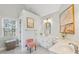 Bright bathroom featuring modern fixtures, ample vanity space, and natural light from a large window at 2849 Shiaway Trl, Snellville, GA 30039