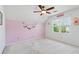Bedroom with sloped ceilings featuring a ceiling fan and a bright window view at 2849 Shiaway Trl, Snellville, GA 30039