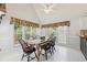 Inviting dining area featuring large windows, an elegant table setting, and light tile floors at 2849 Shiaway Trl, Snellville, GA 30039