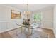 Light-filled dining room featuring elegant chandelier and wainscoting details at 2849 Shiaway Trl, Snellville, GA 30039