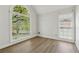 Bright empty room with large windows, light walls, and hardwood floors at 2849 Shiaway Trl, Snellville, GA 30039