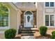 Elegant front door with stone accents, arched window, and decorative wreath at 2849 Shiaway Trl, Snellville, GA 30039