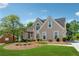 Charming two-story home with lush green lawn, arched windows, and mature landscaping at 2849 Shiaway Trl, Snellville, GA 30039