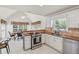 Bright kitchen featuring white cabinets, stainless steel appliances, granite countertops, and an adjacent dining area at 2849 Shiaway Trl, Snellville, GA 30039
