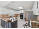 Spacious kitchen features granite countertops, white cabinetry, tile flooring and modern appliances at 2849 Shiaway Trl, Snellville, GA 30039