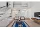 Spacious living room with open staircase, bright white walls, and modern finishes at 2849 Shiaway Trl, Snellville, GA 30039