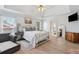 Relaxing main bedroom featuring a tray ceiling, wood floors, a ceiling fan, and neutral decor at 2849 Shiaway Trl, Snellville, GA 30039