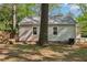 Backyard featuring a deck, lawn, and mature trees, creating a peaceful retreat at 3417 Glen Rd, Decatur, GA 30032