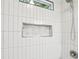 Shower featuring gray tile, a shower head, and inset marble accent tiling at 3417 Glen Rd, Decatur, GA 30032