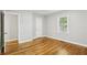 Bright bedroom featuring hardwood floors, neutral paint, and a window bringing in natural light at 3417 Glen Rd, Decatur, GA 30032