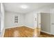 Bedroom featuring hardwood floors, natural light, with a closet and bathroom entrance at 3417 Glen Rd, Decatur, GA 30032