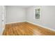 Bright bedroom featuring wood floors, neutral paint, and a window bringing in natural light at 3417 Glen Rd, Decatur, GA 30032