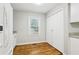 Charming kitchen area featuring wood floors, a window and an adjacent storage closet at 3417 Glen Rd, Decatur, GA 30032