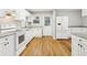 Modern kitchen featuring white cabinets, hardwood floors, granite countertops, and stainless appliances at 3417 Glen Rd, Decatur, GA 30032