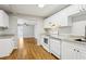 Updated kitchen with white appliances, granite countertops, and hardwood floors at 3417 Glen Rd, Decatur, GA 30032