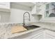 Modern kitchen sink with granite countertops and white cabinets at 3417 Glen Rd, Decatur, GA 30032