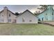 This backyard features a grassy area, a fence, and the home's exterior at 3640 Sapphire Ct, Decatur, GA 30034