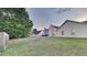 This backyard features a large grassy area and the home's exterior at 3640 Sapphire Ct, Decatur, GA 30034
