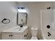 This bathroom features a light vanity, black hardware, a mirror, and a toilet at 3640 Sapphire Ct, Decatur, GA 30034