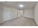 This bedroom features neutral walls and carpet, a ceiling light, and white doors at 3640 Sapphire Ct, Decatur, GA 30034