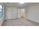 This bedroom features neutral walls and carpet, a ceiling light, white doors, and a window at 3640 Sapphire Ct, Decatur, GA 30034