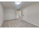 This bedroom features neutral walls and carpet, a ceiling light, and white doors at 3640 Sapphire Ct, Decatur, GA 30034