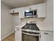 Modern kitchen featuring stainless steel appliances, white cabinets, and quartz countertops at 3640 Sapphire Ct, Decatur, GA 30034