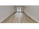 Long room with laminate wood floor, double french doors, and neutral walls at 3640 Sapphire Ct, Decatur, GA 30034