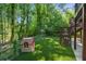 Large grassy yard features playhouse and backs to heavily wooded lot at 3803 Mill Creek Ct, Atlanta, GA 30341