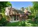 Large backyard includes multi-level deck, lush landscaping, and a playhouse at 3803 Mill Creek Ct, Atlanta, GA 30341